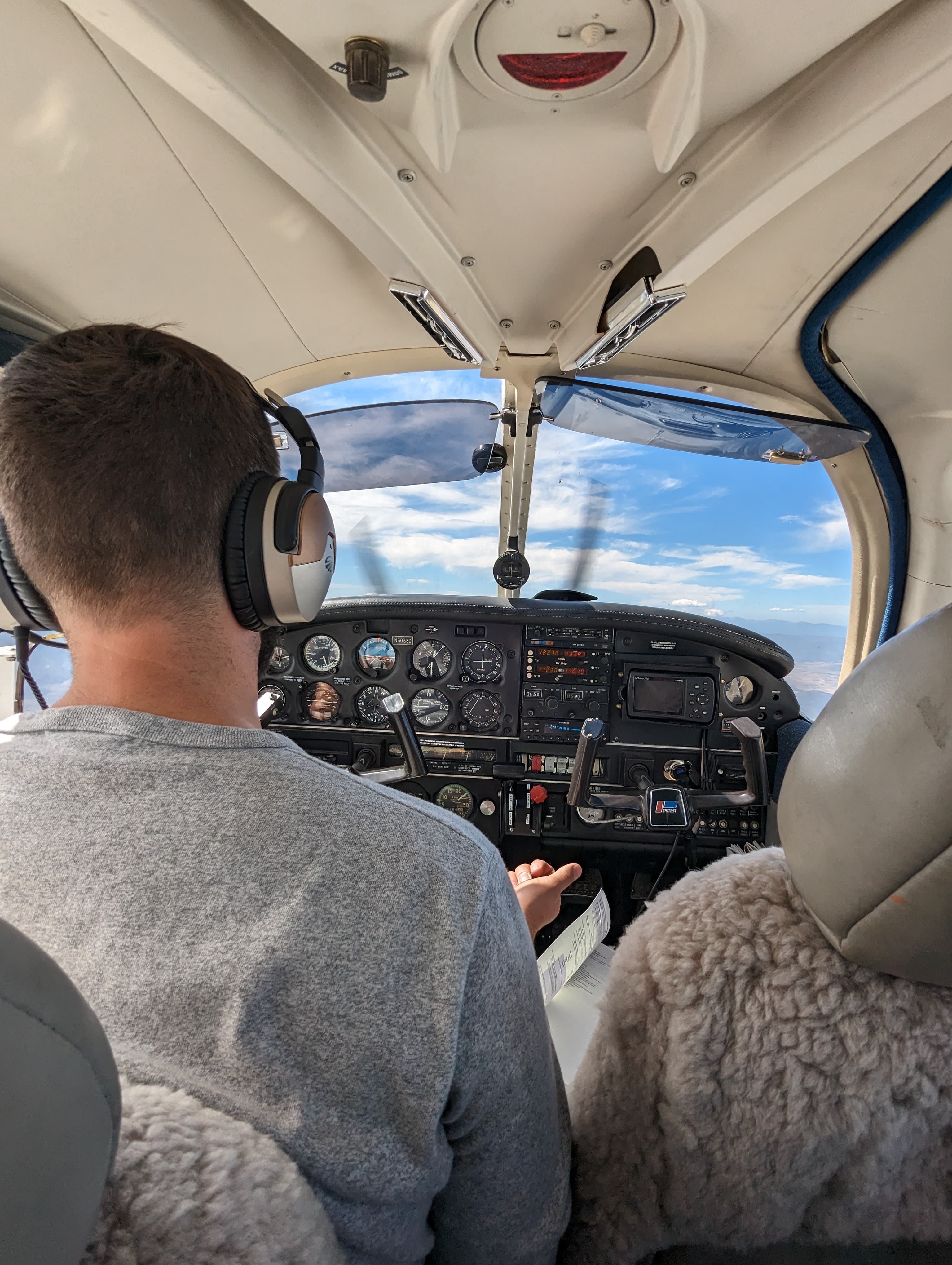 A pilot flying a light aircraft from the cockpit